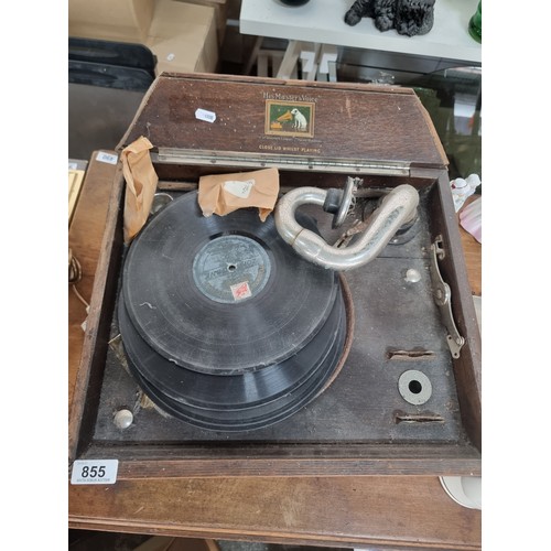 855 - A vintage His Master's Voice gramophone housed in a wooden. With three gramophone records, arm and a... 