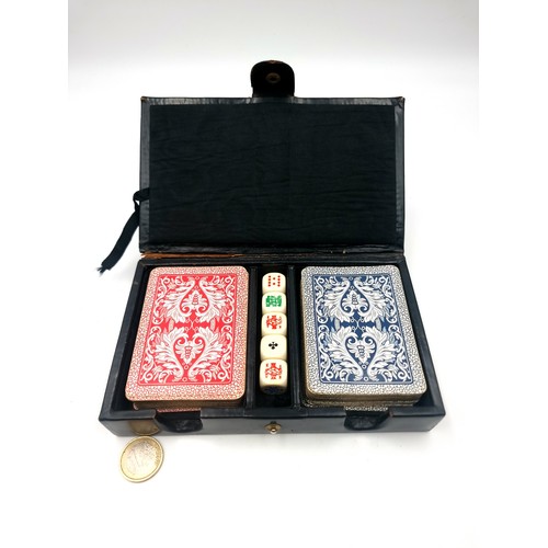 32 - A super cool boxed vintage poker playing card set, which features cards and dice. Encased in a leath... 