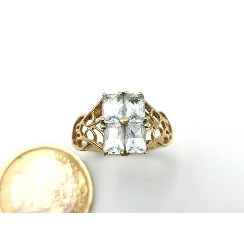 42 - Star Lot : A beautiful vintage 9 carat gold Aquamarine four stone ring, set with attractive floral C... 