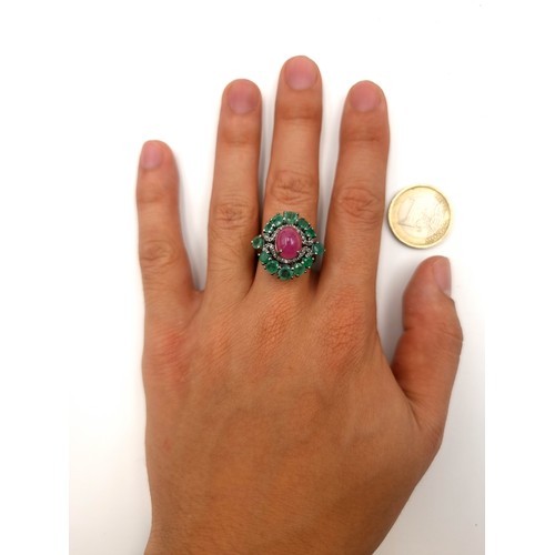 51 - Star Lot : A fabulous Cabochon stone Ruby ring, set with a stunning Emerlad cluster surround halo an... 