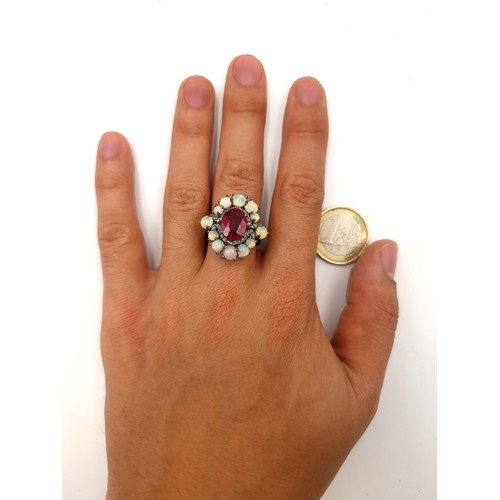 52 - Star Lot : A mesmerising Ruby and Fire Opal ring, set with a shimmering Opal floral flat point halo ... 