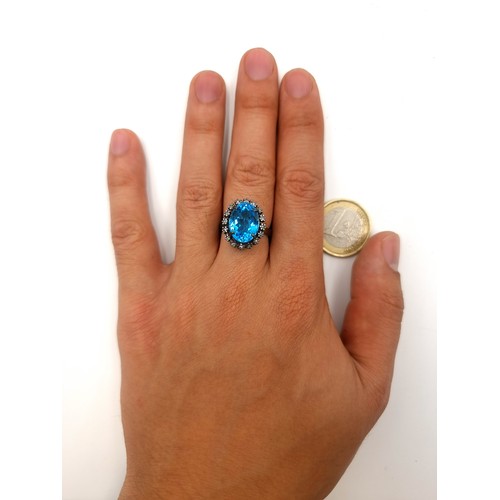 53 - A show stopping vivid Blue Topaz stone ring, set with a huge central stone and a sparkling Diamond s... 