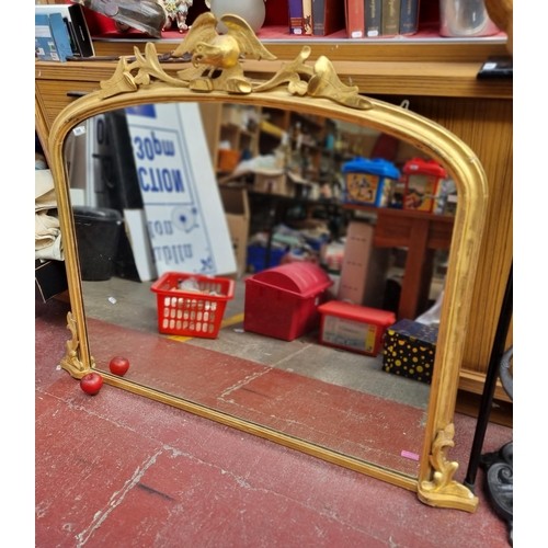 937 - Star Lot : A beautiful example of a large gilded ornate oval mantle mirror, featuring an unusual reg... 