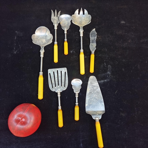 138 - A selection of eight antique unusual tableware with honey Bakelite handles including salad tossers a... 