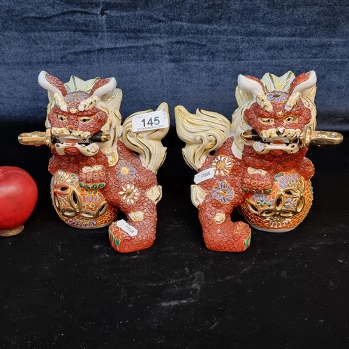 145 - A pair of vintage Chinese ceramic foe dogs with elaborate design.