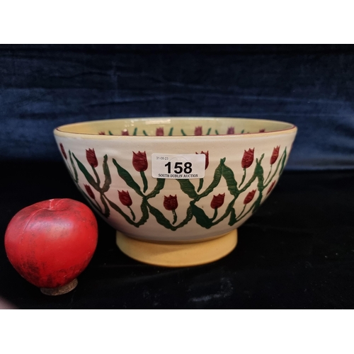 158 - A Nicholas Mosse Pottery 9.5 inch mixing bowl in a tulip pattern. In very good condition and with st... 