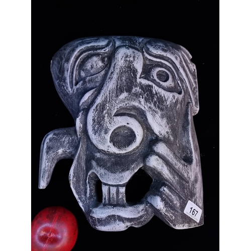 167 - A large unusual Grotesque hand carved wooden tribal mask in a grey finish.