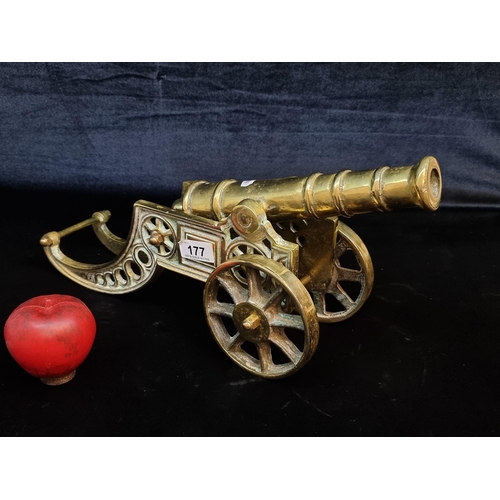 177 - A large heavy brass sculpture of an articulated cannon with rotating wheels and lovely detail throug... 