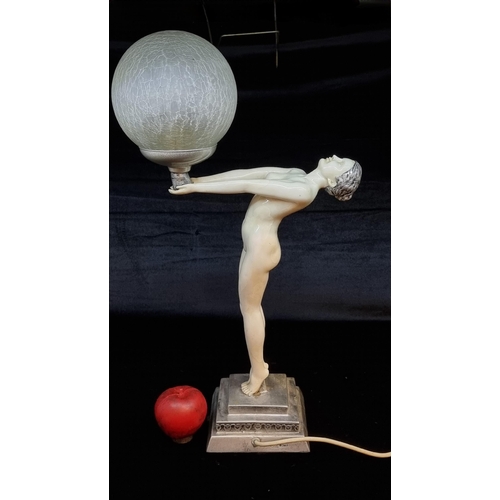 178 - Star Lot : A wonderful large Art Deco style table lamp in the form of a nude woman holding a globe g... 