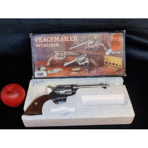 189 - A vintage Denix Peacemaker 45 caliber replica revolver gun with pewter and wooden elements and origi... 