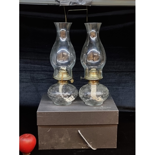 195 - Two matching oil lamps comprising of reservoirs with brass fittings and chimneys.