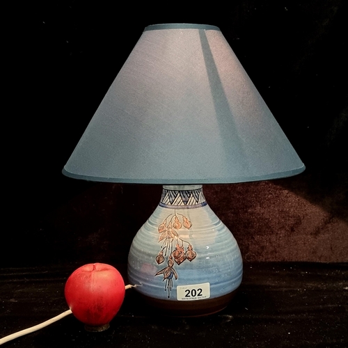 202 - A stylish art studio pottery lamp with shade, three pin plug and signed to base.