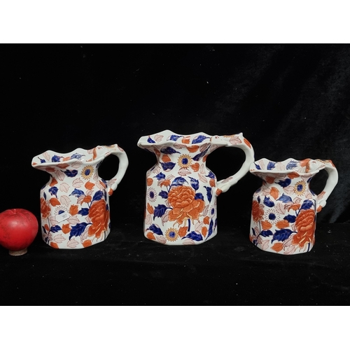 205 - A trio of graduated Victoria ware ironstone jugs in an autumnal pattern. In vgc.