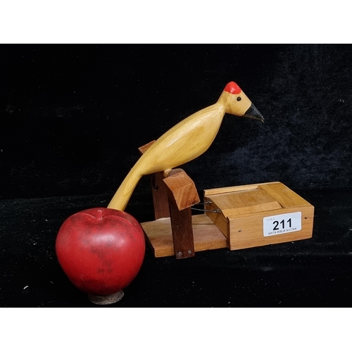 211 - A charming novelty cigarette dispenser in the form of a wood pecker. When you lift his tail his book... 