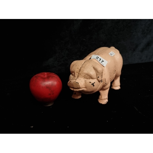 217 - A cast metal pink pig money box.