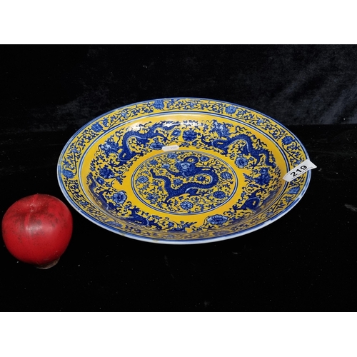 219 - A beautiful large Chinese charger with dragon motif to centre and in fabulous shades of blue and yel... 