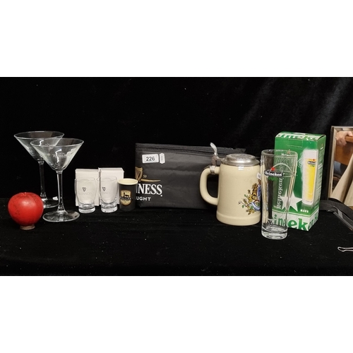 226 - A selection of eight items including a Guinness cooler bag, a vintage stein, shot glasses and two mi... 