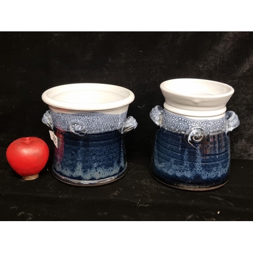 265 - Two studio art pottery jars including a tea caddy. In a navy and white glaze.