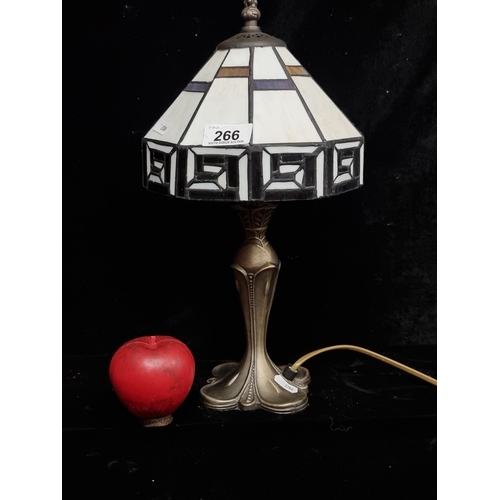 266 - A Tiffany style table lamp with a glass shade and Art Nouveau style brass stem. Fitted with a three-... 