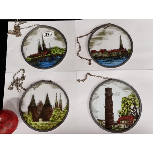 278 - Four round glass paintings depicting various scenes. With hanging chains.