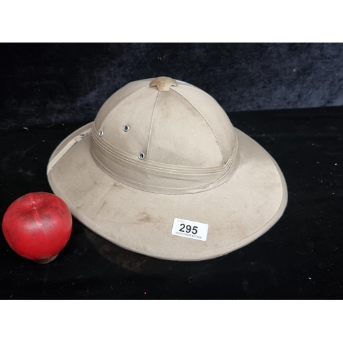 295 - A vintage pith helmet with a strap to top and leather banding to interior.