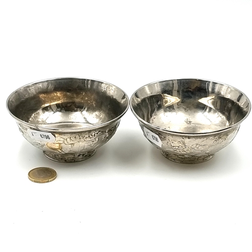 40 - A duo of silver plated Japanese raised circular tea bowls, each set with a dragon motif. Total weigh... 