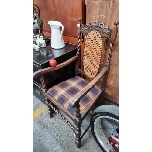 692 - A handsome carved oak barley twist carver chair, with rattan back and upholstered in a tartan fabric... 