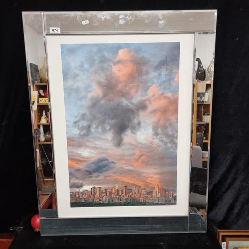 74 - A large photographic print by Hank Gans showing Manhattan skyline dominated by dramatic sunset cloud... 