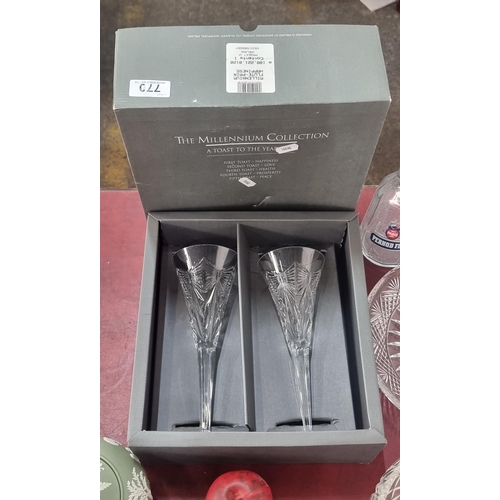 770 - A pair of large Waterford Crystal Champagne flutes from the Millennium Collection. In original box w... 