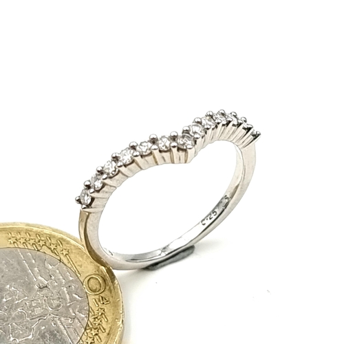 918 - Star Lot : A brilliant cut 9 carat White Gold thirteen stone Diamond wish bone half eternity ring. S... 