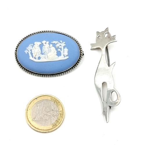 928 - A very fine Wedgwood cameo brooch along with a sterling silver brooch in the form of a stylised cat.... 