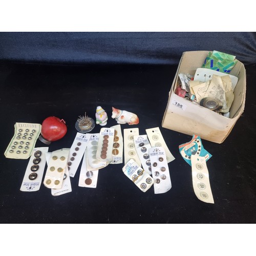 155 - A huge collection of vintage sewing items including buttons, tape measures and pin holders.