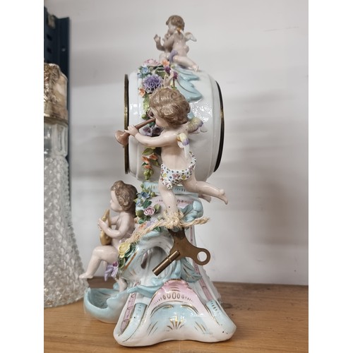 159 - Star Lot : A fabulous Antique porcelain French mantle clock with an ornate case featuring cherubs an... 