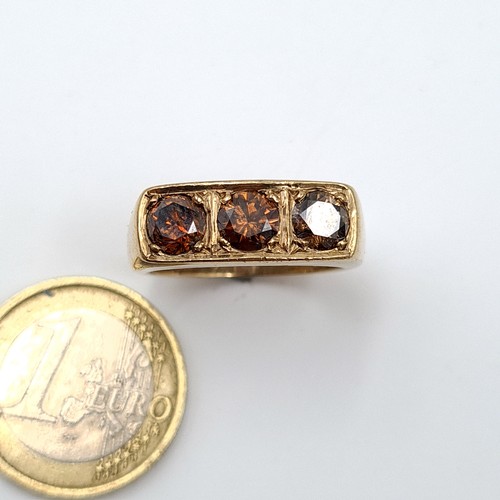 5 - Star Lot : A mesmerising substantial 9 carat gold generous three stone natural Topaz ring, featuring... 