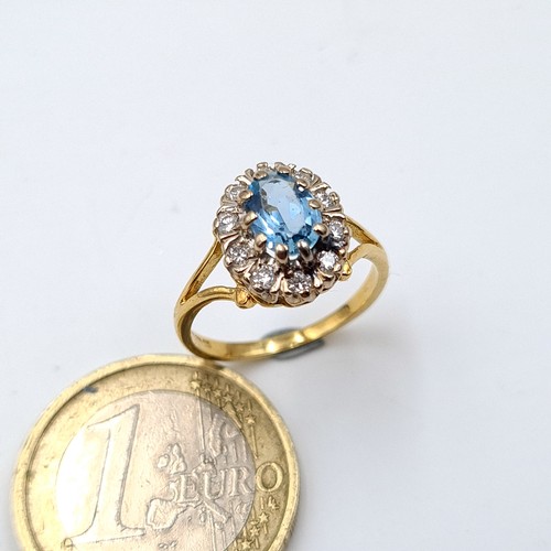 6 - Star Lot: A truly beautiful vintage 18 carat gold Aquamarine cluster ring, set with a generous halo ... 