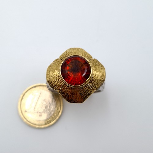 7 - Star Lot : A Stunning  and unusual  18 carat gold and silver ring, set with a beautiful central Garn... 