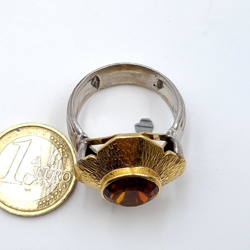 7 - Star Lot : A Stunning  and unusual  18 carat gold and silver ring, set with a beautiful central Garn... 