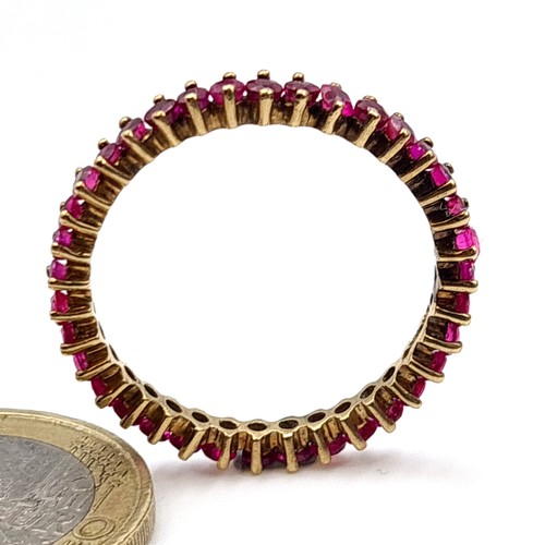 11 - Star Lot: An exquisite full eternity 35 stone natural Ruby 9 carat gold ring. Ring size: V. Weight: ... 