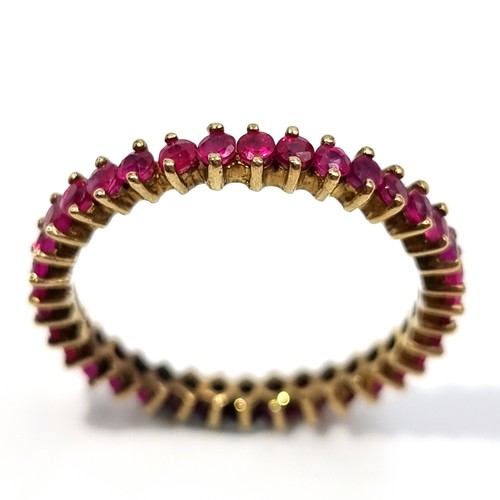 11 - Star Lot: An exquisite full eternity 35 stone natural Ruby 9 carat gold ring. Ring size: V. Weight: ... 