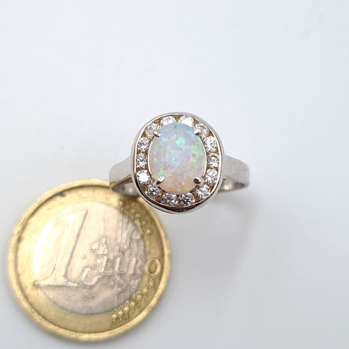 13 - Star Lot : A striking 14 carat White Gold Fire Opal and diamond ring. Ring size: P. Weight: 3.41 gra... 