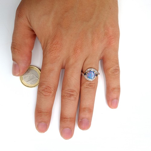 15 - Star Lot : A fabulous example of a vintage 10 carat gold generous Blue fire Opal stone ring, set wit... 