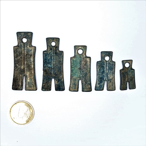 45 - A collection of five graduated metal pendants, each set with Egyptian hieroglyphic design.