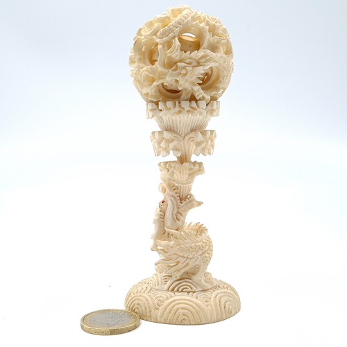 60 - A finely carved Japanese antique natural material puzzle ball and pedestal. Combined height: 13cm. W... 