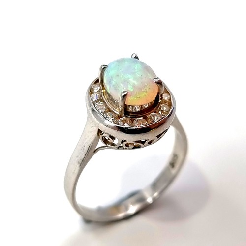 13 - Star Lot : A striking 14 carat White Gold Fire Opal and diamond ring. Ring size: P. Weight: 3.41 gra... 