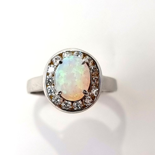 13 - Star Lot : A striking 14 carat White Gold Fire Opal and diamond ring. Ring size: P. Weight: 3.41 gra... 