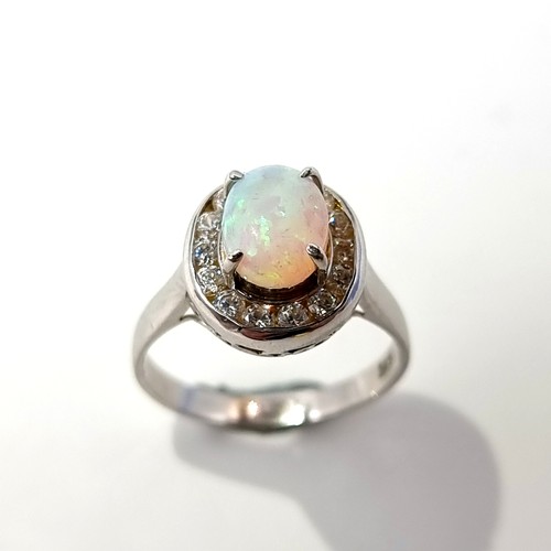 13 - Star Lot : A striking 14 carat White Gold Fire Opal and diamond ring. Ring size: P. Weight: 3.41 gra... 