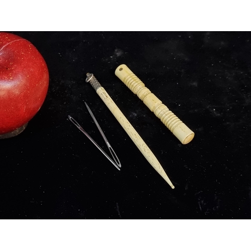 155 - Two nineteen century bone sewing items including a carved stanhope needle case and a bone plated lay... 