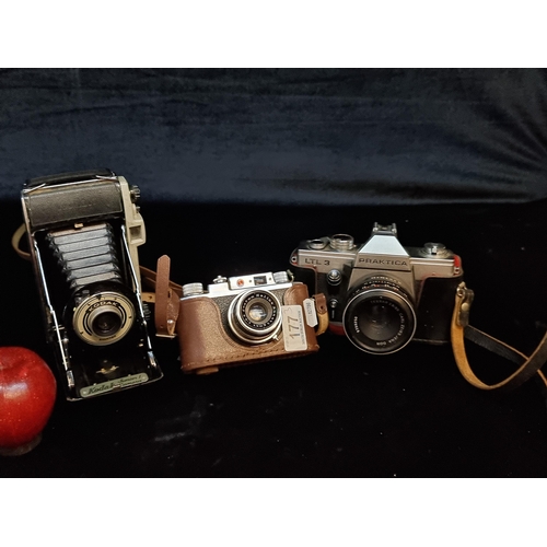 177 - Three vintage cameras including a Kodak Jr Bellows, a Praktica LTL 3 and a Halina 35X made in German... 