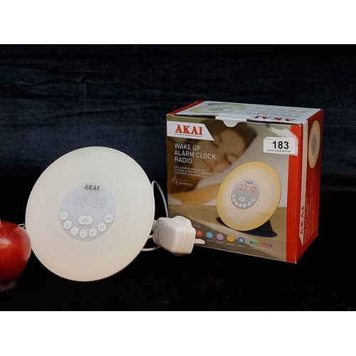 183 - A boxed Akai wake up alarm clock radio with remote multiple colour ring and Fm Radio.