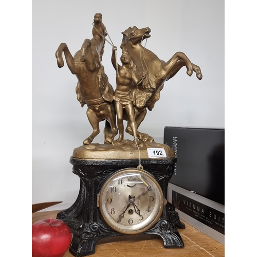 192 - Star Lot : An ornate vintage German made mantle clock topped with a man leading two horses in gilded... 